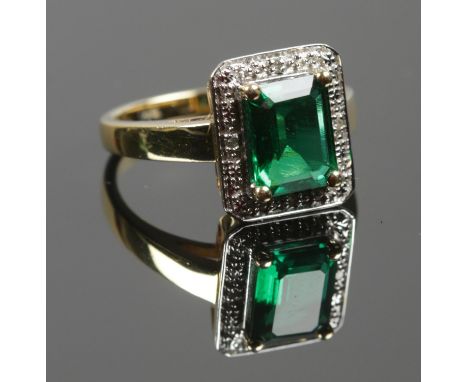 A boxed Silver gilt ring with a green stone and diamond edge. Stamped 925 to inside. Size O. Total weight: 4.38g.  