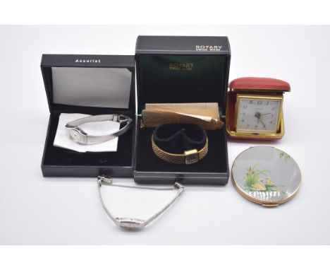 Three ladies wristwatches; together with a compact; and a travelling clock. 