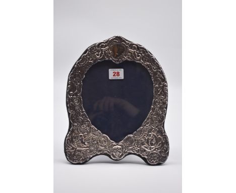 An embossed silver easel back photograph frame, by D R &amp; S, London 1986, 26cm high. 