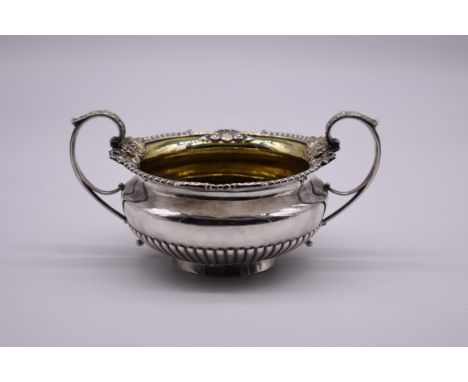 A George III silver gilt lined twin handled sugar basin, by W Elliot, London 1818, 10.5cm high, 458g. 