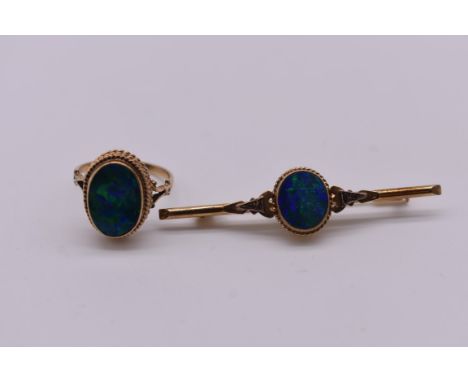 An oval opal gold ring, stamped 9ct; together with a similar bar brooch stamped 10k, 5cm, (both opals are doublets).