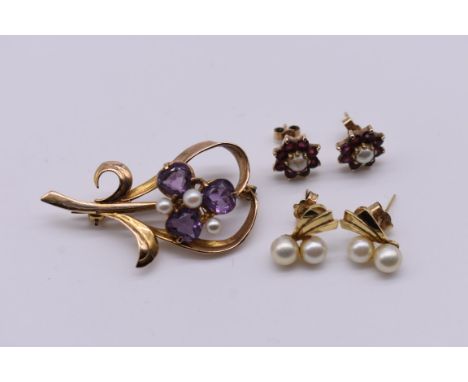 An amethyst and pearl floral brooch, stamped 9ct, 5.6g; together with two pairs of yellow metal earstuds, set pearl and garne