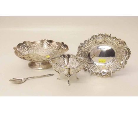 Three pierced silver dishes, one with a spoon. Condition report: see terms and conditions'.
