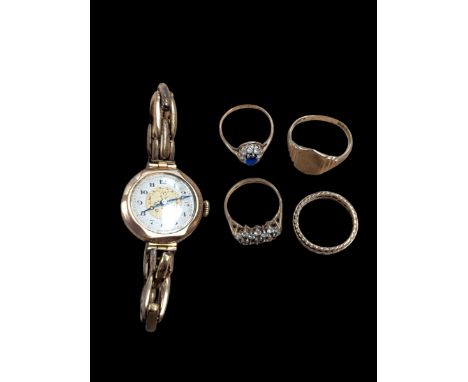 Four 9ct gold rings, including signet ring and three stone set rings, together with a ladies manual wind rolled gold wristwat