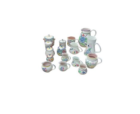Poole Pottery, floral pattern, including five preserve pots and ten jugs of various sizes 
