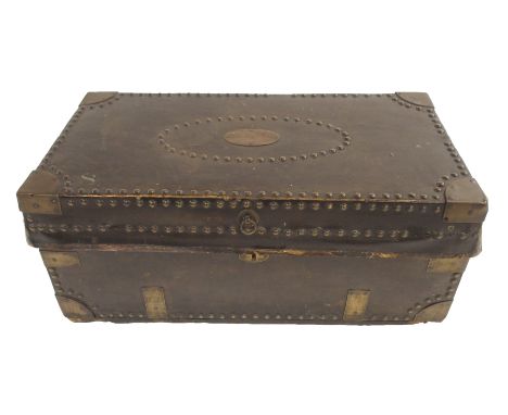AN EARLY 19TH CENTURY NAVAL TRUNK leather and brass bound inscribed to G. A. Moore with studded border and strapping with car