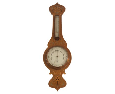 AN ARTS AND CRAFTS OAK, BRASS AND FRUITWOOD INLAID WHEEL BAROMETER AND THERMOMETER T Baird &amp; Sons, Glasgow, 93cm high Con