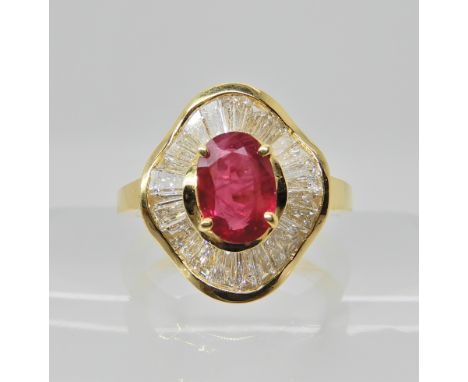 AN 18CT GOLD RUBY AND DIAMOND DRESS RING dimensions of the ruby 7.9mm x 5.6mm x 3.3mm, estimated approx total of tapered bagu