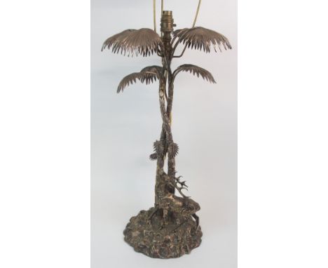 A SILVER PLATED CENTREPIECE MODELLED AS STAG baying beneath a palm tree on naturalistic craggy base (converted to a lamp), 62