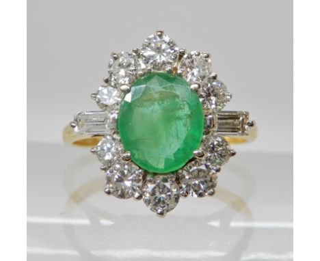 AN 18CT GOLD EMERALD AND DIAMOND CLUSTER RING central emerald dimensions 7.7mm x 6.9mm x 2.6mm, surrounded with baguette and 