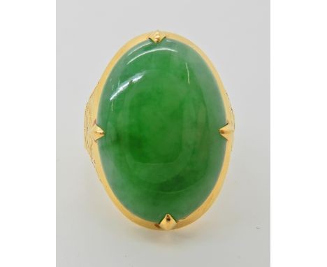 A HIGH CARAT CHINESE GOLD MALAYAN JADE RING the hardstone measures 23mm x 16.5mm x 6.2mm, in decorative mount with full Chine