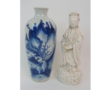 A CHINESE BLUE AND WHITE VASE painted with a mountainous landscape and calligraphy, 24cm high and a blanc de chine figure of 