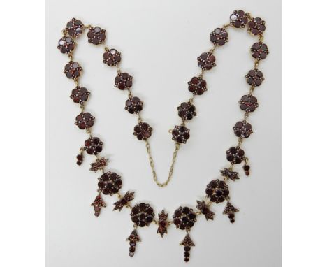 A GILDED WHITE METAL GARNET NECKLACE of floral theme, length 45cm, weight 23.5gms Condition Report: Two small garnets missing