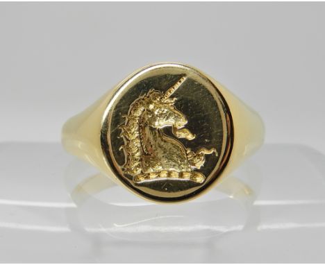 AN 18CT GOLD SIGNET RING INTAGLIO CARVED WITH A UNICORN hallmarked London 1971. Head size 14mm x 12mm, finger size V1/2, weig