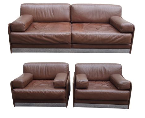 A CONTEMPORARY BROWN LEATHER THREE PIECE SUITE with chrome base rails and side support fittings comprising; sofa, 73cm high x