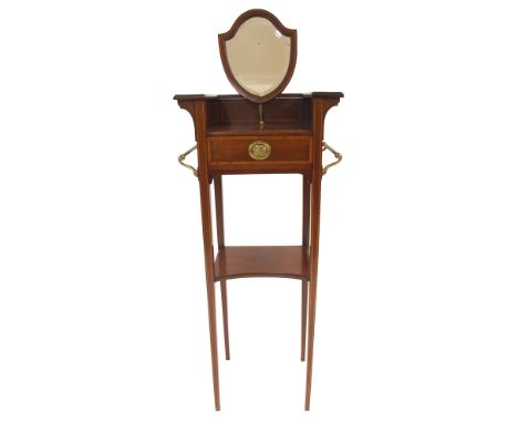 AN EDWARDIAN MAHOGANY AND SATINWOOD BANDED WASH STAND with shield shaped mirror above a drawer flanked by a pair of brass tow