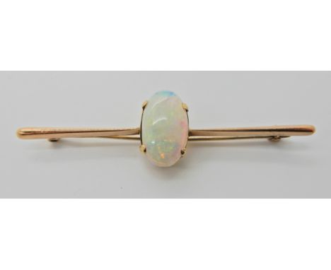 A 9CT WHITE OPAL BAR BROOCH dimensions of the opal 15.9mm x 9.3mm x 4.6mm. Length of brooch 6.2cm. Weight 3.7gms Condition Re