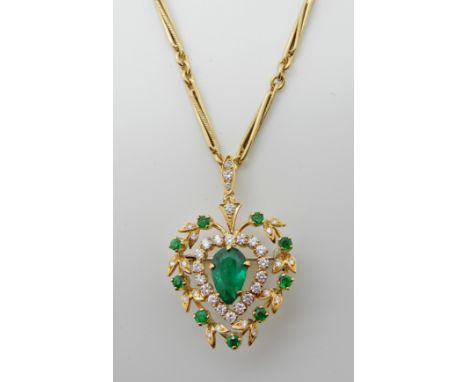 AN 18CT GOLD, EMERALD AND DIAMOND PENDANT BROOCH the pear shaped central emerald is approx 9.5mm x 6mm x 3.9mm and surrounded