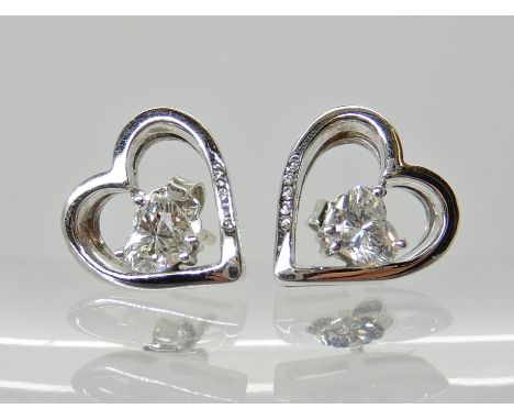 A PAIR OF 18CT WHITE GOLD HEART SHAPED DIAMOND EARRINGS each set with an estimated approx 0.35ct heart shaped diamond and fur