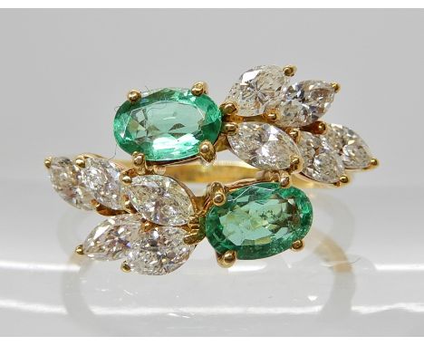 AN 18CT GOLD DIAMOND AND EMERALD SPRAY DESIGN RING emeralds approx 6mm x 4mm x 2.9mm, with marquis diamond leaf shapes to eit