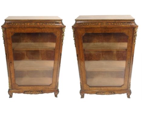 A PAIR OF VICTORIAN WALNUT PIER CABINETS with single glazed door, marquetry inlay and ormolu mountings, 116cm high x 75cm wid