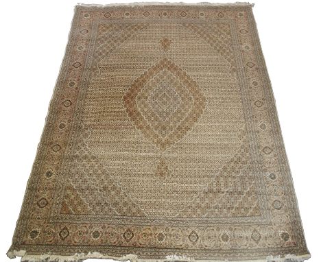A LARGE TABRIZ RUG light ground with a central medallion, darker spandrels and borders, 393cm x 293cm Condition Report: Good 
