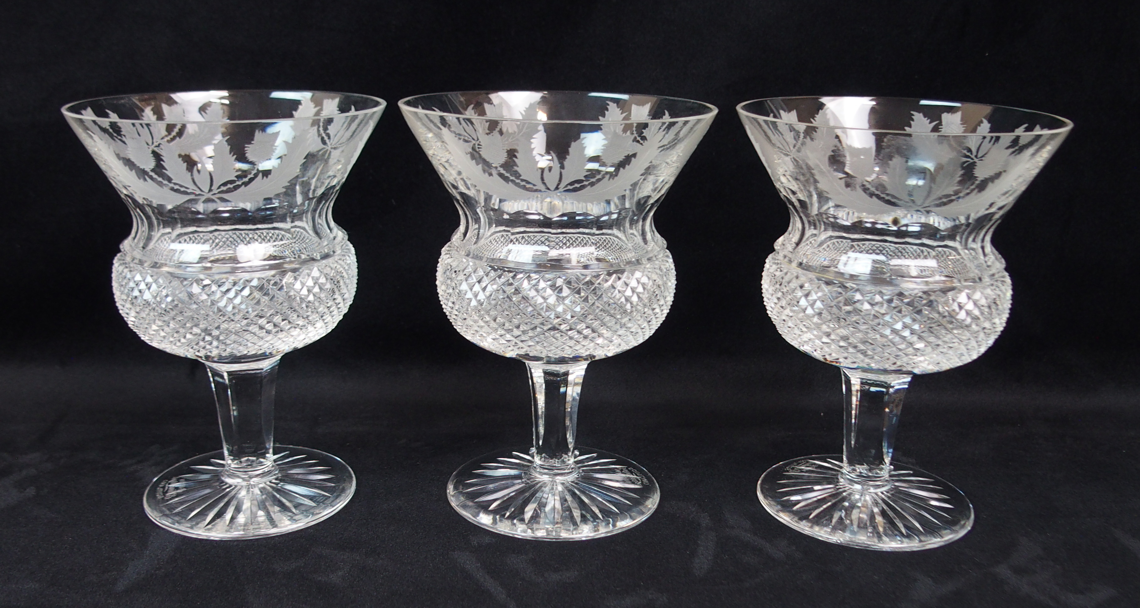 A SUITE OF EDINBURGH CRYSTAL THISTLE SHAPED DRINKING GLASSES including