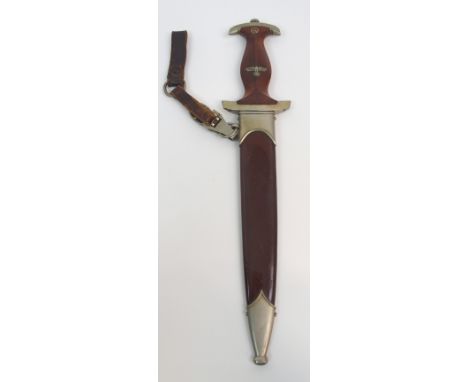 A GERMAN SA DAGGER the 22cm blade marked "Alles for Deutschland", the hilt inlaid with eagle and Swastika and emblem, the cro