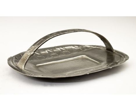 Liberty & Co Tudric pewter oval cake dish, designed by Archibald Knox, having a loop handle and with stylised foliate decorat