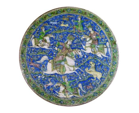 Persian Qajar cuerda seca polychrome decorated circular pottery panel typically showing a hunting scene on a blue ground and 