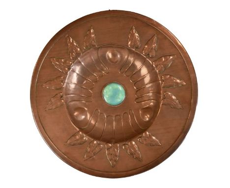 Arts & Crafts copper charger having embossed leaf decoration emanating from a deep well with a mottled green Ruskin type cera
