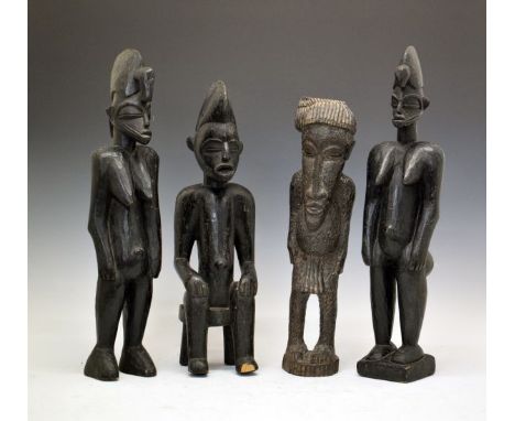 Ethnographica - Pair of African Senufo carved wooden figures, each depicting a standing female, 57cm and 58cm high, a similar