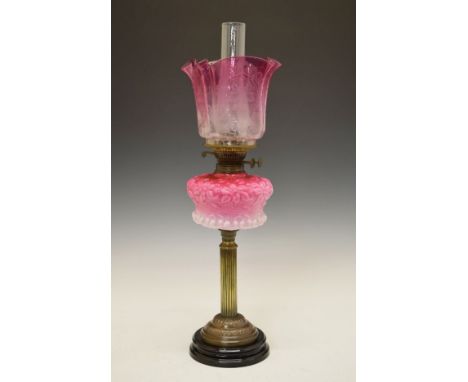 Victorian oil lamp, shaded pink glass reservoir with stylised foliate decoration in relief, reeded column having a domed foot