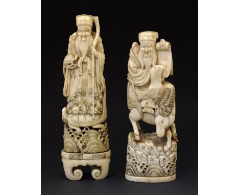 Two 19th Century Chinese carved ivory figures, each depicting a bearded deity, one standing atop a tortoise, the other seated