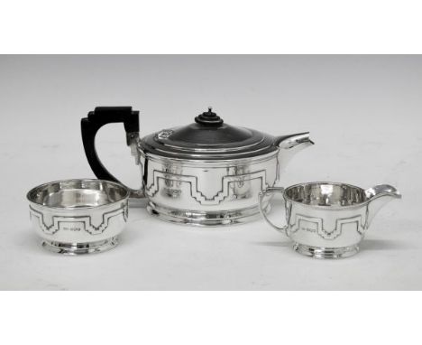 George V silver Art Deco design three piece tea set having stylised stepped decoration in relief, makers Walker & Hall, Sheff