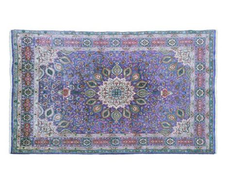 Modern Tabriz wool carpet decorated with a central medallion on a tight-knit foliate purple ground within multi borders, 356c