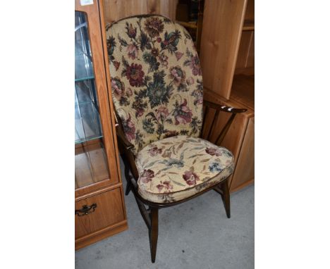 A traditional dark stained Ercol Windsor chair, having spindle frame
