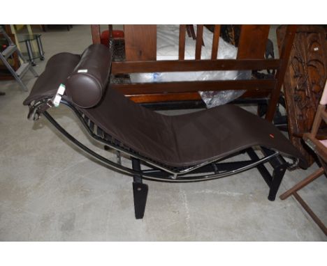 A modernist style chaise longue, having chrome frame, Le Corbusier design, brown leather upholstery, a few light marks else l