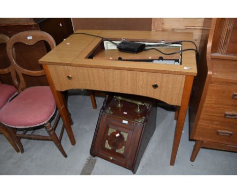 A vintage Singer sewing machine table with integral machine