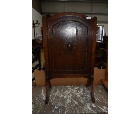 A mid 20th Century oak firescreen