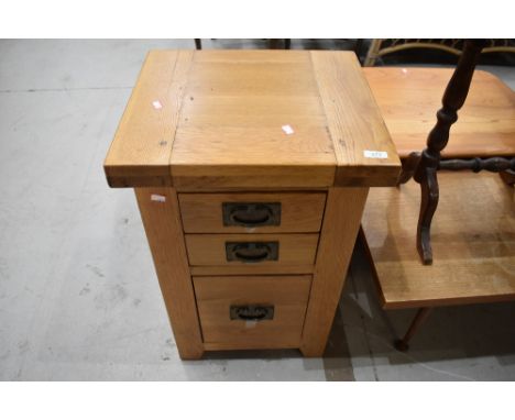 A modern golden oak bedside chest, light scratching to top else in very good condition, handles have tape on, presumably been