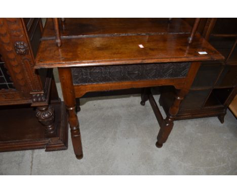 A period oak side table, having lincrusta style frieze panel