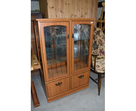 A vintage laminate display cabinet, approx dimensions W83cm H125cm D40cm