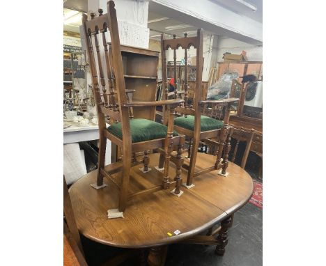 An Ercol old colonial dining table, plus four chairs and two carvers