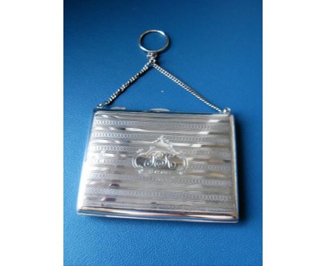 A George V silver cocktail purse / aid memoir with engine turned design, monogrammed with lined interior / ivory page and pen