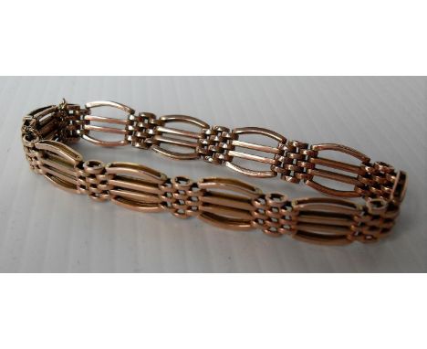 A 9ct yellow gold gate-link lady's bracelet with safety chain, hallmarked, 15g 