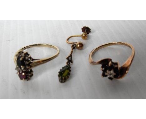Two 9ct yellow gold rings: one sapphire and diamond, the other sapphire and ruby, size R, T, and a peridot drop earring with 