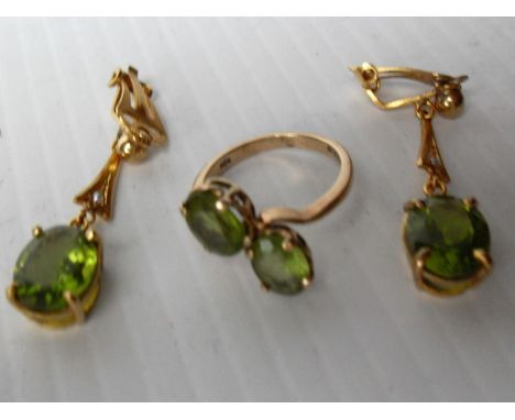 A 9ct yellow gold two-stone peridot ring, size L and a pair of matching clip-on drop earrings to double bezel coronet setting