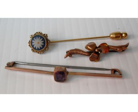 Two 9ct yellow gold brooches, one amethyst set and a stick pin with floral-inset decoration,. Gross weight: 5.57g and a small