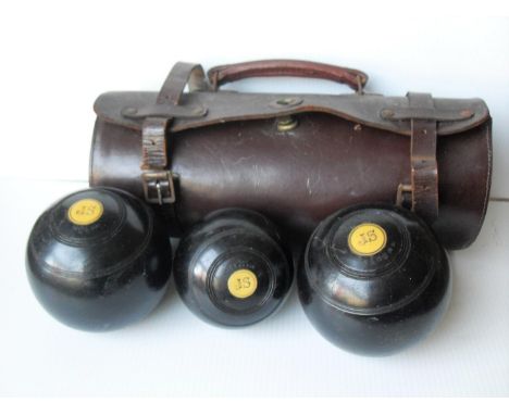 A vintage set of three Thomas Taylor lignum vitae, 2 1/4 bias, monogrammed in leather carry case 